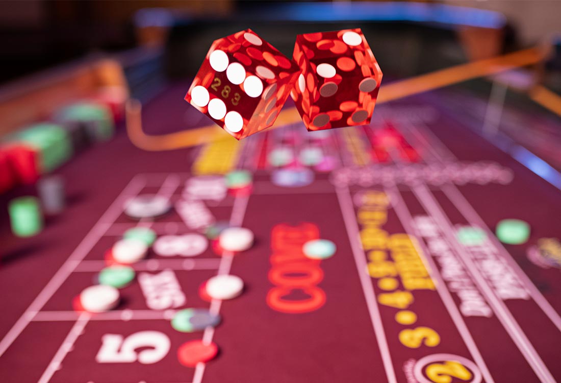 Rolling dice in the air for a game of Craps